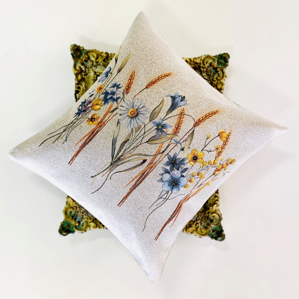 Decorative pillow with floral embroidery on a white background