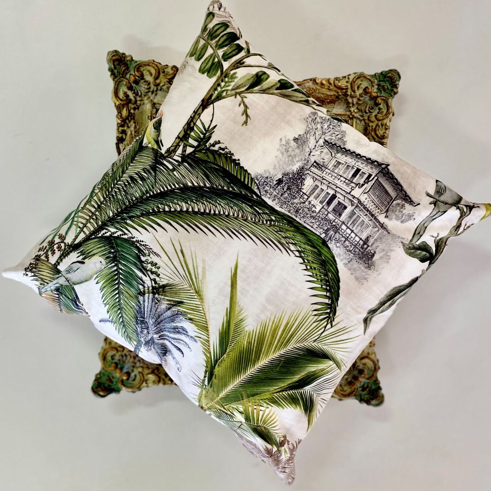 Decorative pillows with leaf and architectural designs on a light background