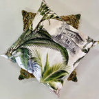Decorative pillows with leaf and architectural designs on a light background