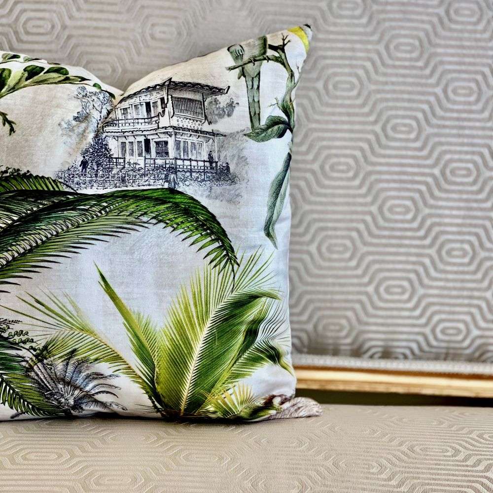 Decorative pillow with tropical design on a textured surface