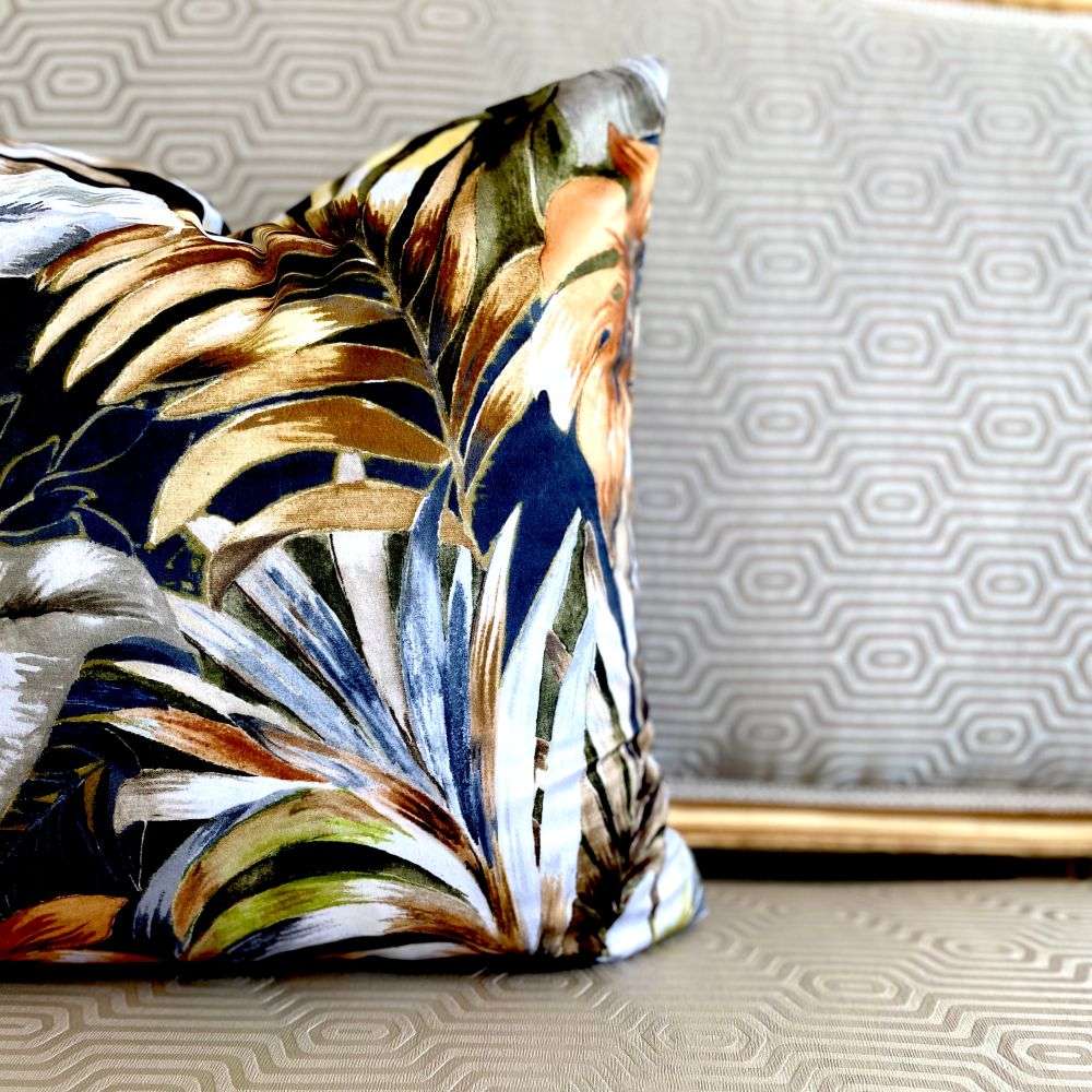 Decorative pillow with tropical leaf pattern on a textured surface