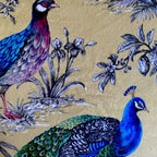Decorative fabric with peacock and bird design on a beige background