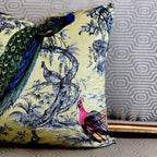 Decorative pillow with peacock and bird design on a textured surface