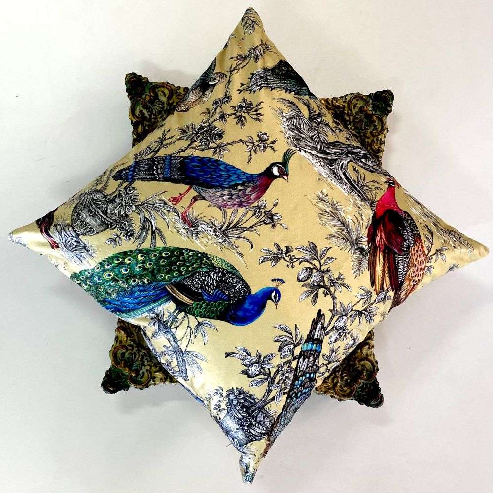 Decorative pillows with peacock and bird patterns on a white background