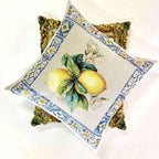 Decorative pillow with lemon design on a white background