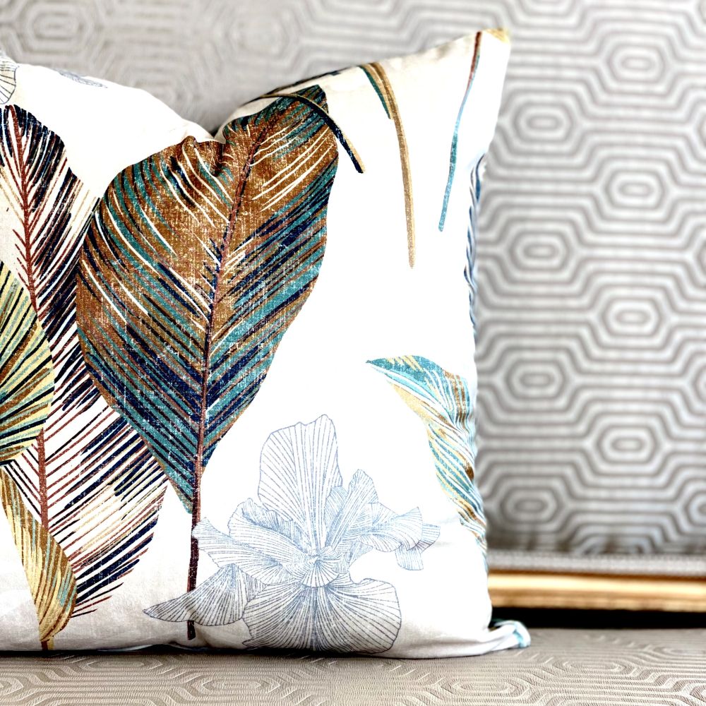 Decorative pillow with leaf patterns on a neutral background