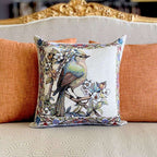 Decorative pillow with a bird design on an orange couch