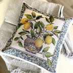 Decorative pillow with lemon design and floral patterns on a neutral background