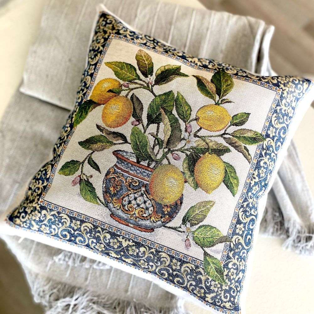 Decorative pillow with lemon design and floral patterns on a neutral background