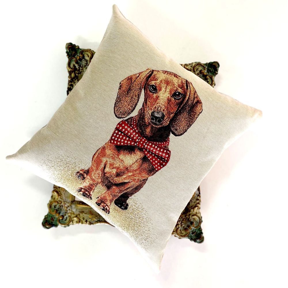 Decorative pillow with a dachshund wearing a red bow tie on a white background