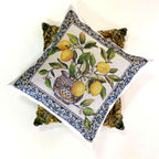 Decorative pillow with lemon and vase design on a white background
