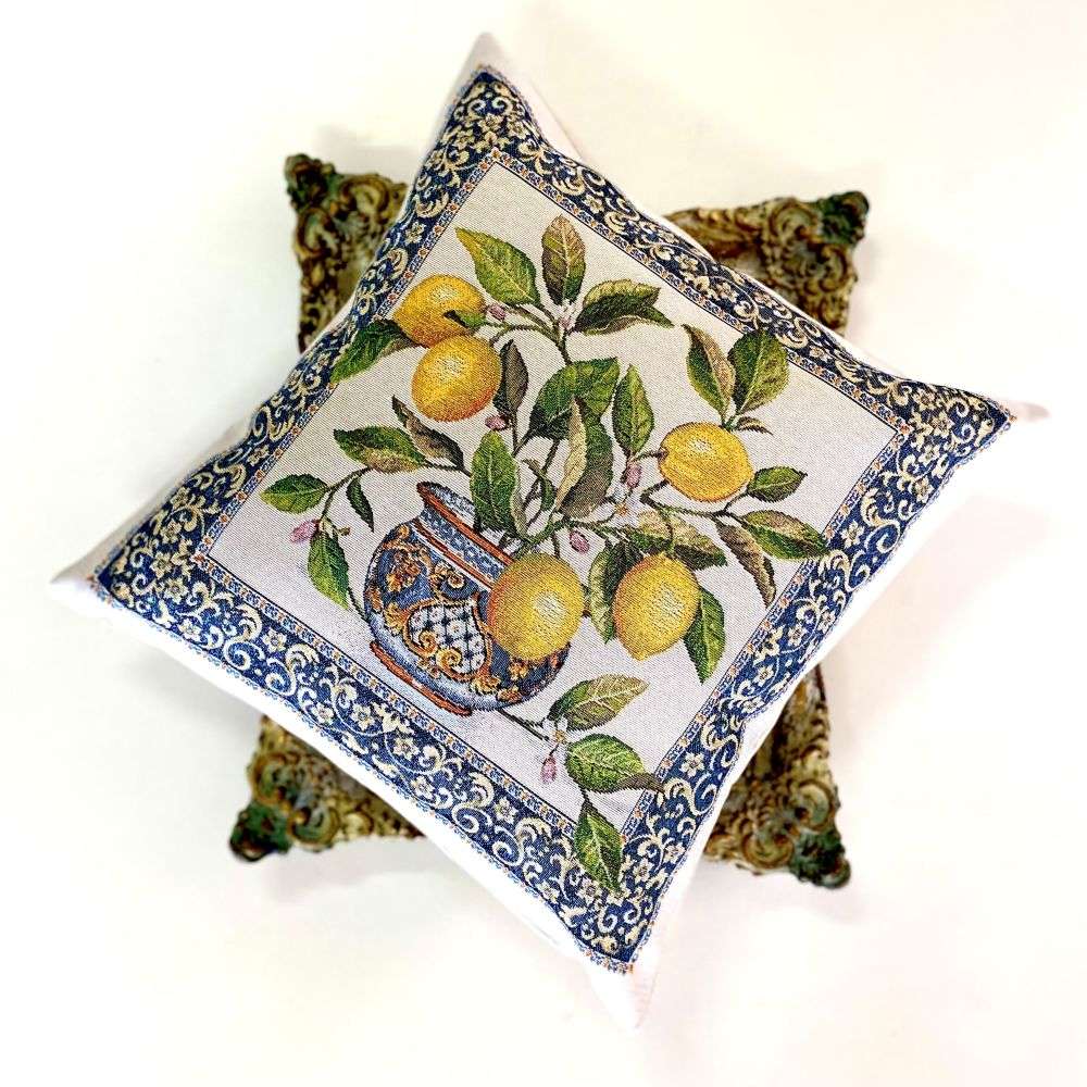 Decorative pillow with lemon and vase design on a white background