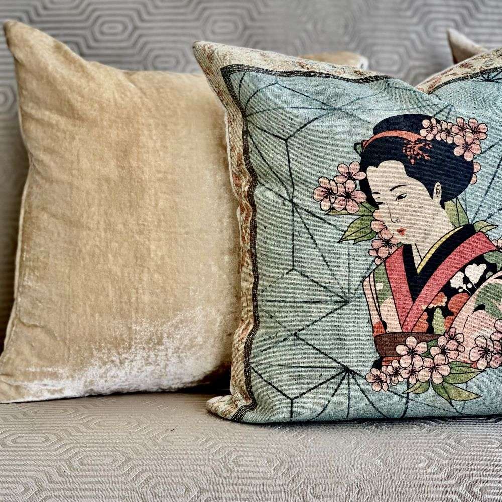 Decorative pillow with a geisha design on a couch