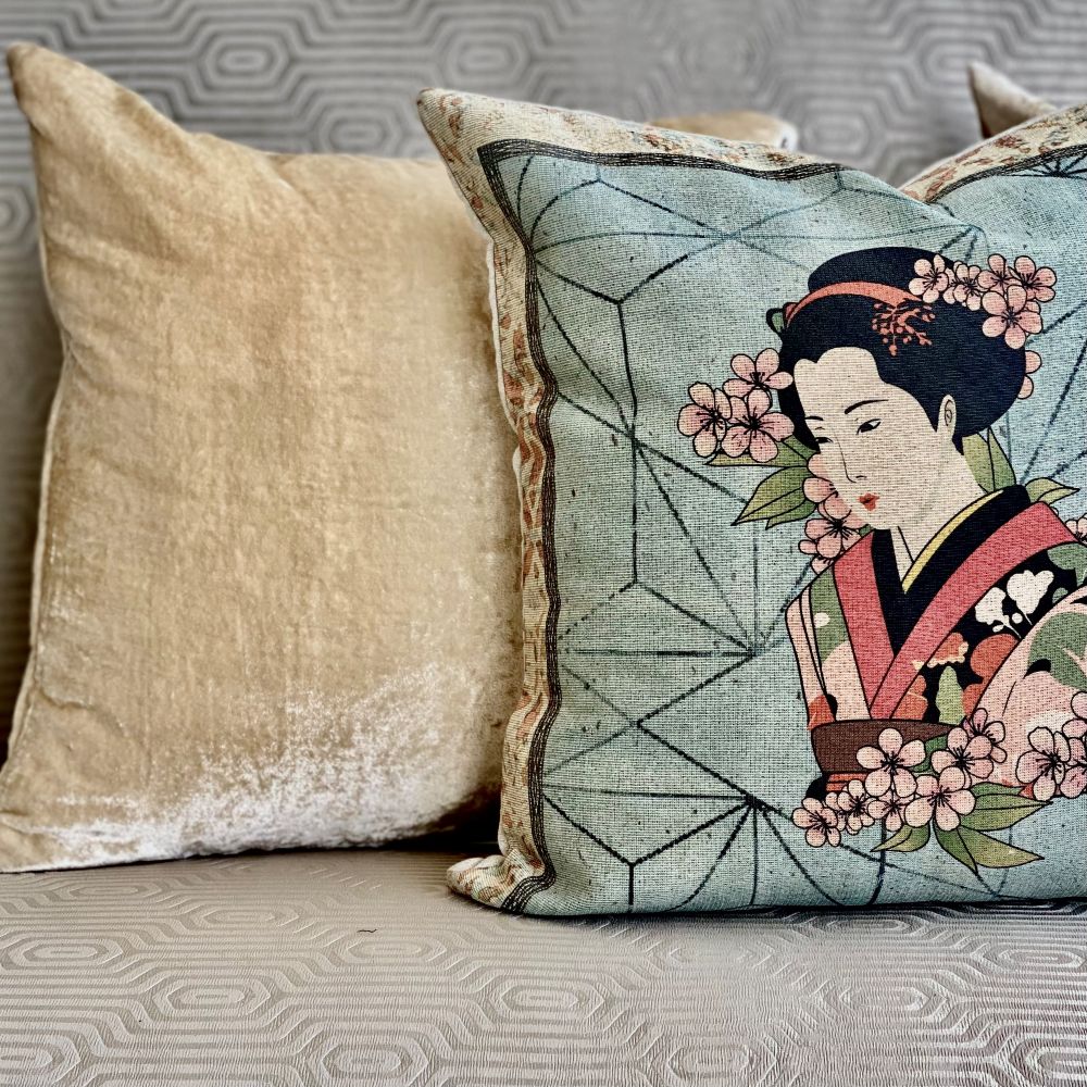 Decorative pillow with a geisha design on a couch