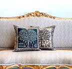 Decorative pillows with tree designs on a ornate sofa.