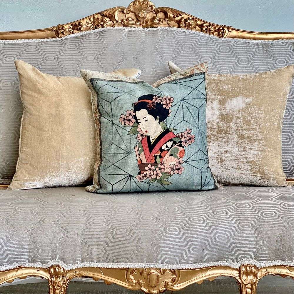 Decorative pillow with a geisha design on a patterned sofa