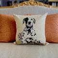 Decorative pillow with a Dalmatian dog design on a couch.