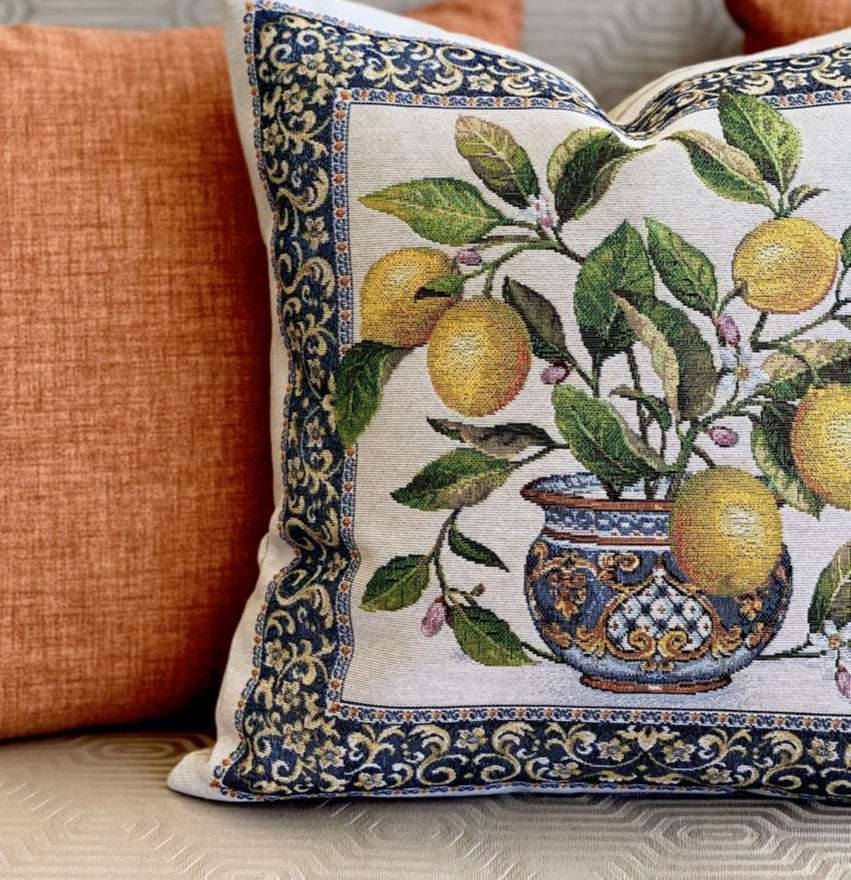 Decorative pillow with lemon and vase design on a neutral background