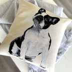 Pillow with a black and white dog illustration on a neutral background