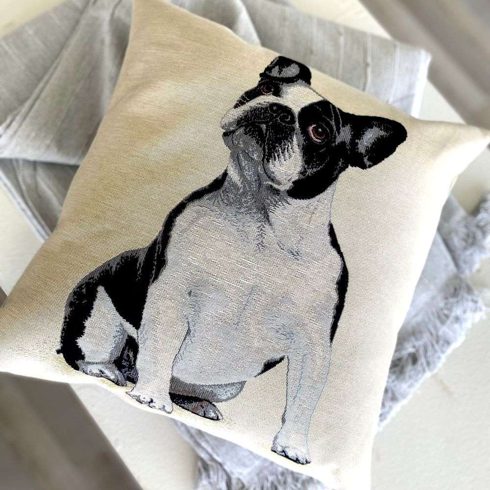 Pillow with a black and white dog illustration on a neutral background