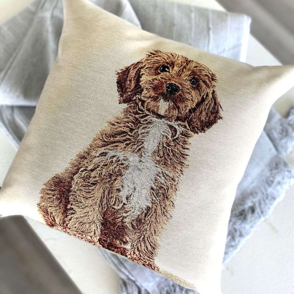 Pillow with a embroidered dog design on a neutral background