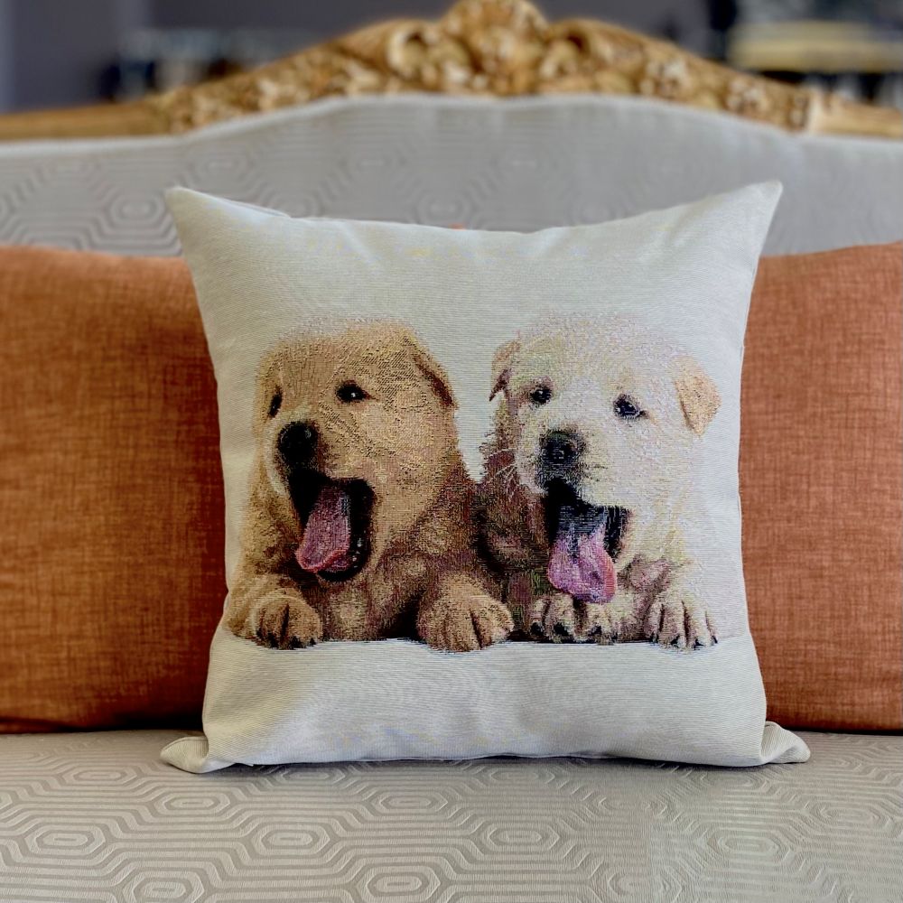 Decorative pillow with two puppies on a couch