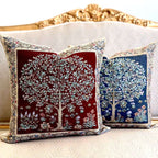 Two decorative pillows with tree designs on a neutral background