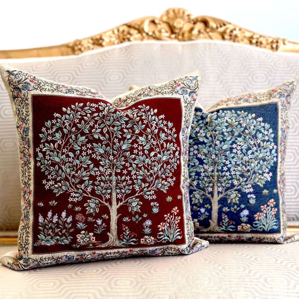 Two decorative pillows with tree designs on a neutral background