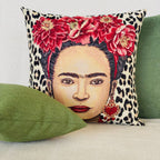Decorative pillow with a portrait design featuring flowers and leopard print on a couch.