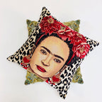 Decorative pillow with a face design, floral headband, and leopard print pattern on a white background.