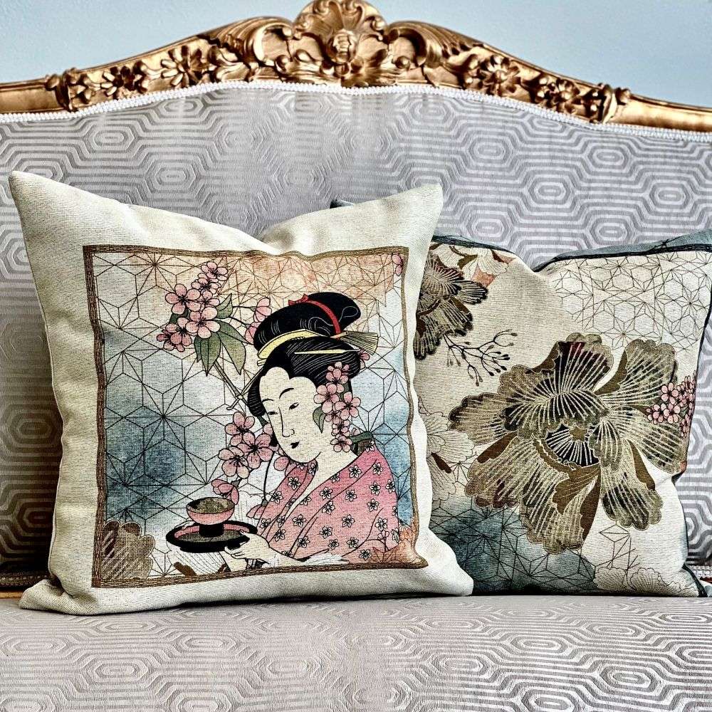 Decorative pillows with Asian-themed designs on a patterned sofa.