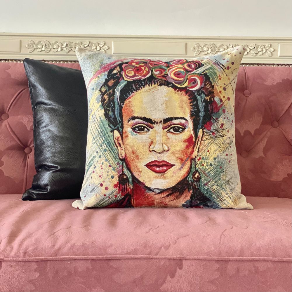 Decorative pillow with a portrait design on a pink couch