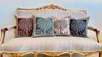 Decorative pillows with tree patterns on a ornate gold and white sofa.