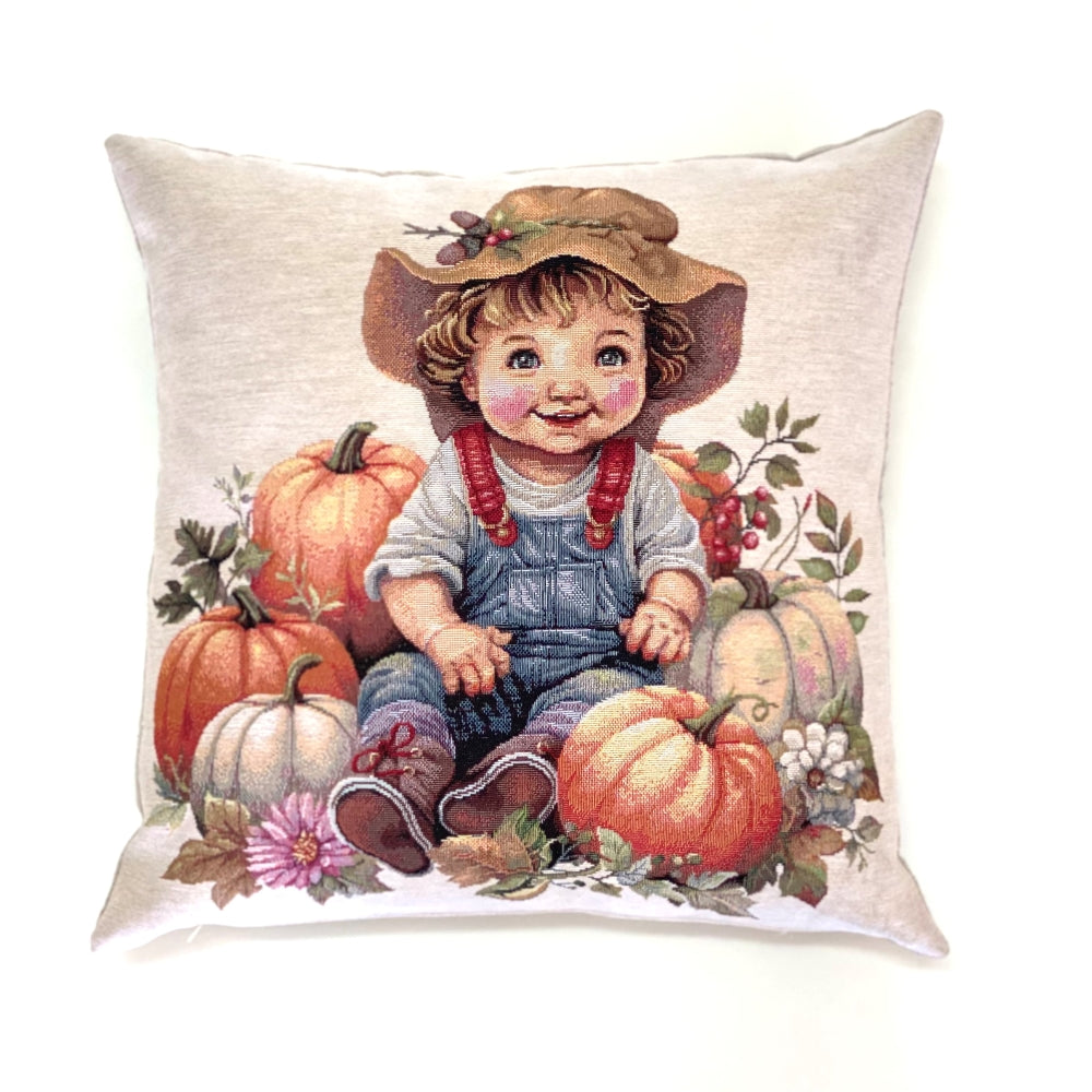 Decorative pillow with a vintage-style illustration of a child in overalls and hat surrounded by pumpkins.