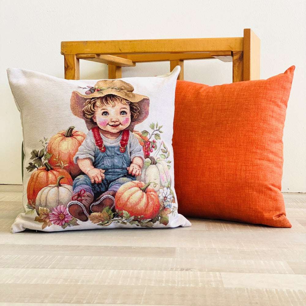 Decorative pillow with a child and pumpkins design on a wooden chair.